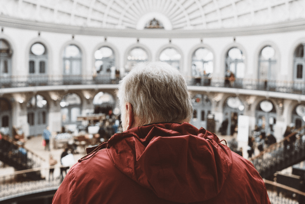 old man looking in a museum